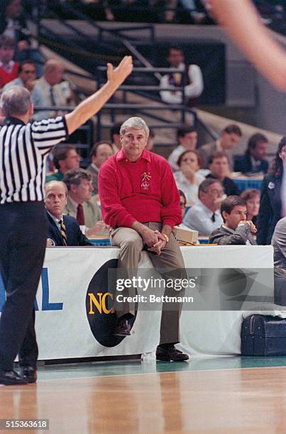 Charlotte, N.C.: A sedate Indiana coach Bob Knight sits on the scorer's table with his hands folded as he watches his number three ranked team lose...