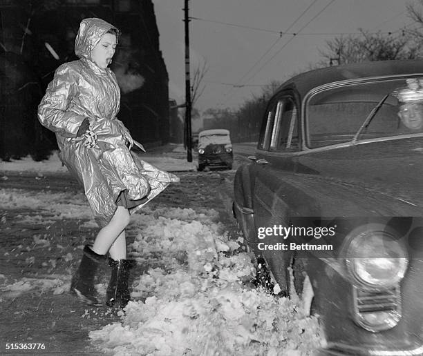 Vintage photograph of trendy young woman splashed over with semi melted snow