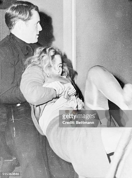 Actress Frances Farmer battles officers seeking to take her to jail cell after her arrest as a parole violator. Officer T.W. MacDonald is shown with...