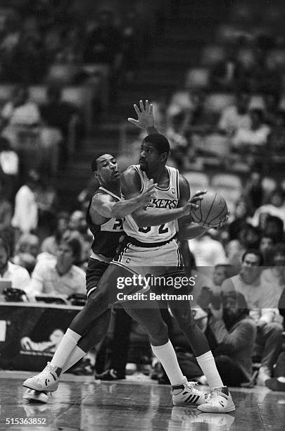 Indiana Pacers guard John Long tries to block Los Angeles Lakers' Magic Johnson from passing the ball to a teammate during the first period at the...
