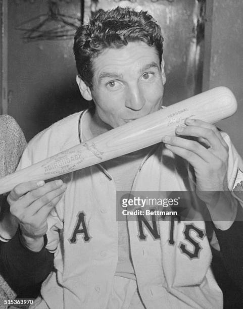 Few bats have done so much for so many, and New York Giants Bobby Thomson bestows an appreciate kiss on the wood with which he blasted his team to...
