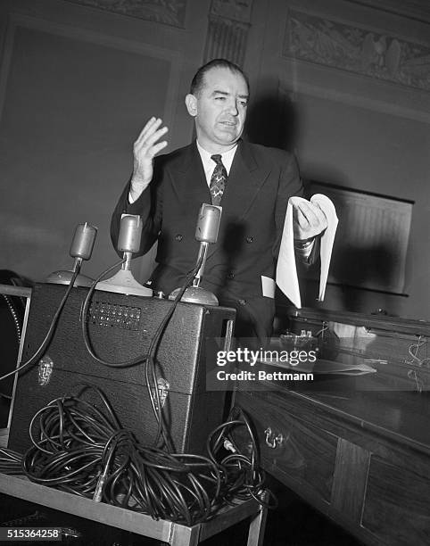 Senator Joseph R. McCarthy stands by the tape recorder that caused all the row at the pre-trial hearing of his slander suit against Senator William...