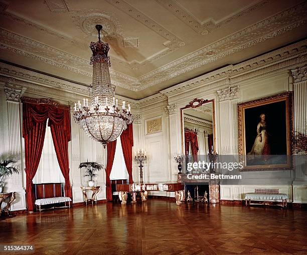 Photo shows a long view of the East Room, where the larger social functions of the White House are held. It is in this huge ballroom that the White...