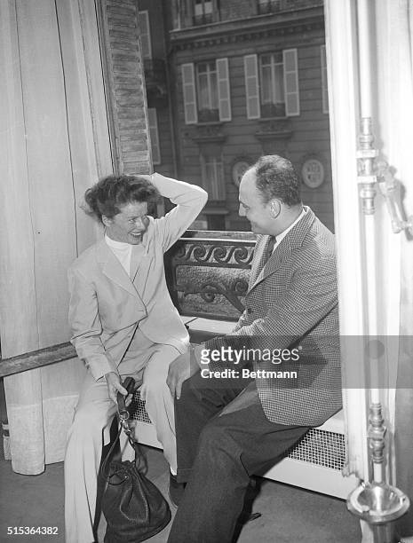 Stage and screen actress Katharine Hepburn has a smiling conference with fashion designer Pierre Balmain in Paris, April 19, about the dresses she is...