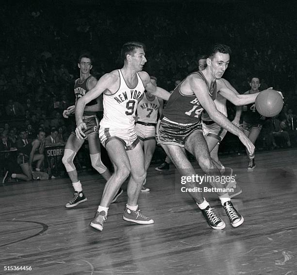 Bob Cousy, of the Boston Celtics, is shown dribbling by Ernie Vanderweghe of the New York Knickerbockers in basketball game.