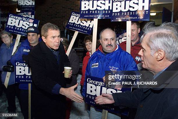 Republican presidential hopeful, Texas Governor George W. Bush makes appeals to voters as he shakes hands with a New Hampshire voter 01 February,...