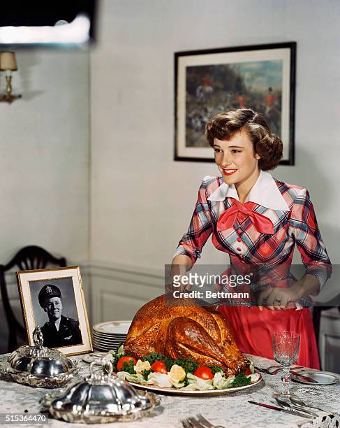 While the men are away during the holidays fighting in World War II, Phyllis Thaxter still cooks a turkey. If you notice there is a picture of a...