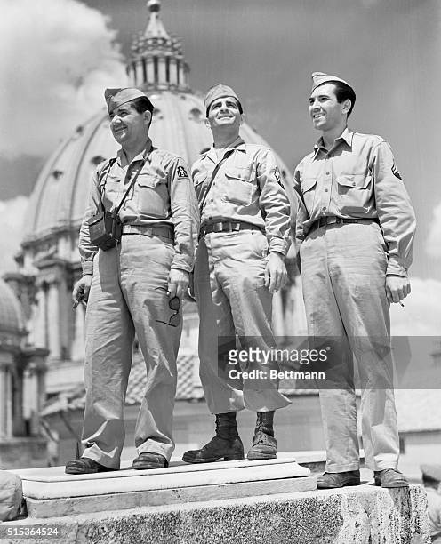Rubbering in Rome. Rome, Italy: Three GI sightseers of the Fifth Army pause during a sightseeing tour of the Eternal city to have their photograph...