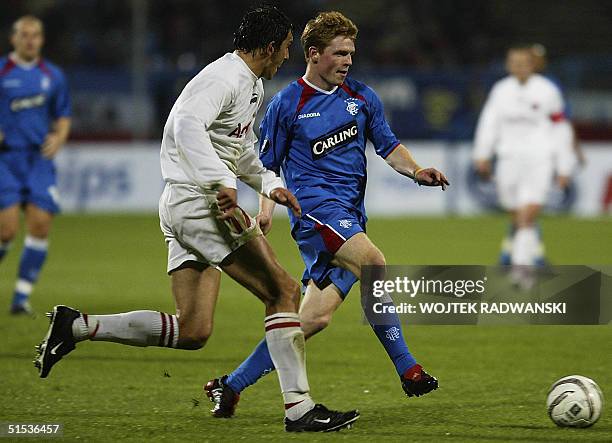 Christopher Burke from Glasgow Rangers and Dariusz Dudka from Amica Wronki fight for a ball during the UEFA Cup match at the stadium in Wronki 21...