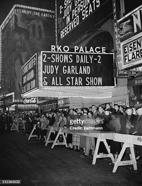 Police barriers hold back a huge crowd outside the Palace Theater, during the opening of a two day Vaudeville stand by actress Judy Garland. The...