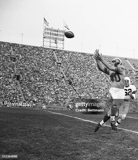Los Angeles, California: Snaring A Pass. Elroy "Crazy Legs" Hirsch Los Angeles Rams' end, reaches to snare a pass on the Cleveland Browns' 37 yard...