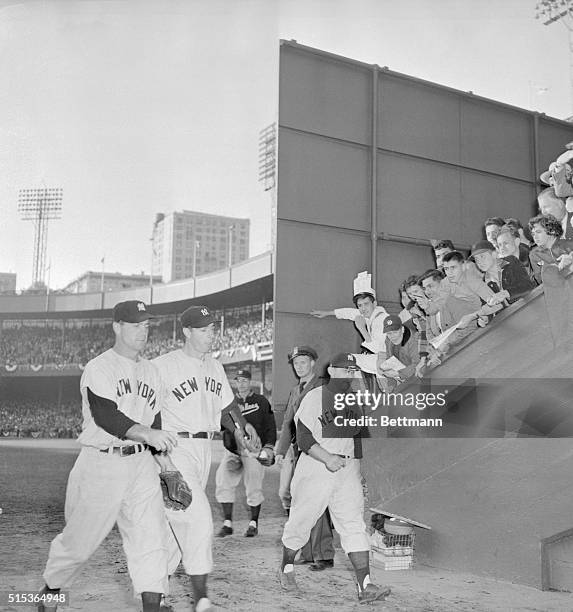 New York: Joe Came Through. Yankees Joe DiMaggio, Hank Bauer, , and Gene Woodling , head for the dressing room at the Polo Grounds, after blasting...