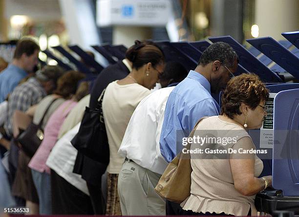 Hispanic voters go to the polls for early voting at the Miami-Dade Government Center on October 21, 2004 in Miami, Florida. Early voting began this...