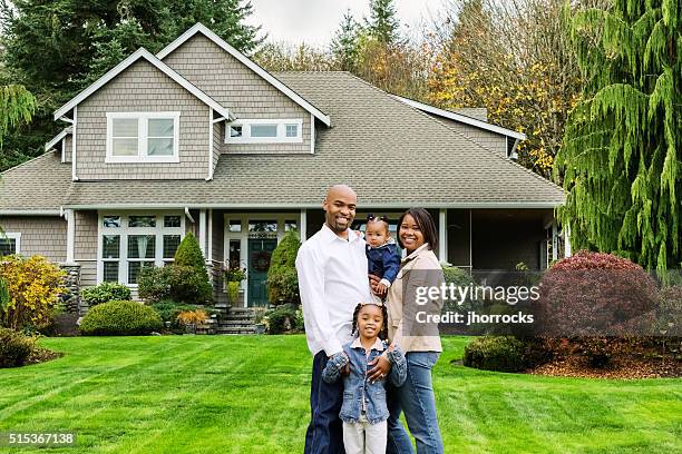 family of four at home in front yard - family home exterior stock pictures, royalty-free photos & images