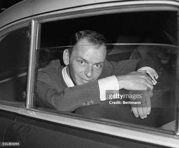 Hollywood singer, Frank Sinatra, looks quizically into a press camera shortly after a conference with the Rome press where he denied reports that he...