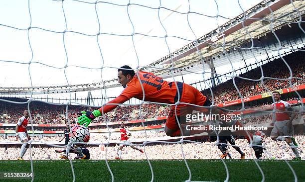 Odion Ighalo of Watford (obscured scores their firstgoal past goalkeeper David Ospina of Arsenal during the Emirates FA Cup sixth round match between...