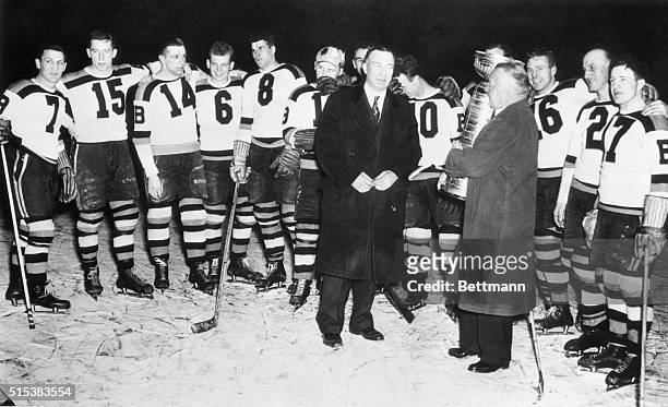 Frank Calder , president of the National Hockey League, presenting the Stanley Cup, emblematic of the World's hockey championship, to manager Art...