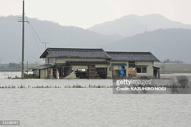 House is flooded in Izushi town, Hyogo Prefecture, 22 October 2004, in the aftermath of typhoon Tokage. The death toll from Typhoon Tokage rose to 67...