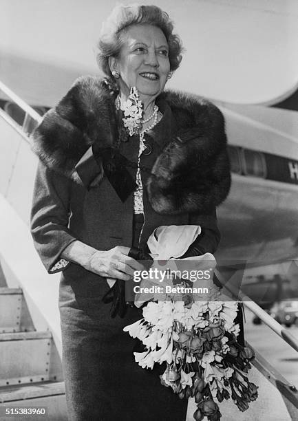 Cosmetics expert Elizabeth Arden arrives at London airport.