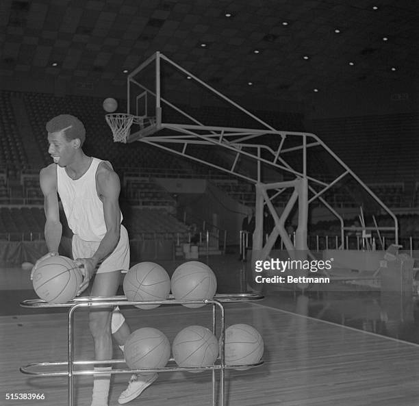 All-American Charlie Scott, super star of the Tar heels, picks up a ball prior to a brief workout at Freedom hall 3/19. University of North Carolina...