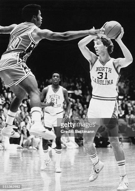 Detroit guard Wilbert McCormick puts an aerial defense against Carolina's Mike O'Koren during first half action of their 12/4 contest which Carolina...