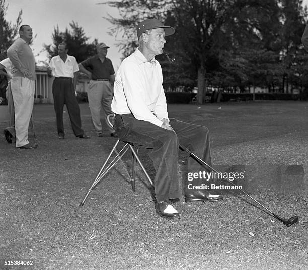 ‘Puffing' on an unlighted pipe, the Duke of Windsor awaits his turn at the tee during the Four Ball Amateur Invitational Tournament at Havana,...