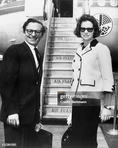 Film director, Sidney Lumet and wife, Gloria Vanderbilt, are shown about to board an Air France jet at New York International Airport bound for Paris...