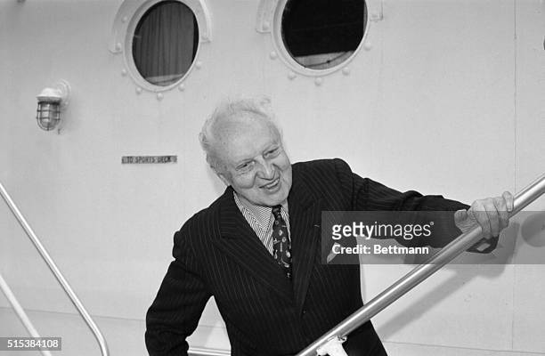 Symphony Orchestra conductor Leopold Stokowski has a big smile before leaving for London aboard the liner United States. The Maestro proudly...