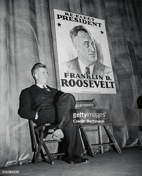 Henry Wallace, Vice Pres. Of the U.S. Sitting next to campaign poster 'Re-elect President F.D.R.