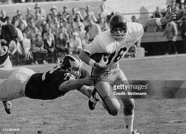 Sandy Durko gains yardage in the opening minutes of the Rose Bowl game for USC before being brought down by Michigan's Dan Dierdorf.