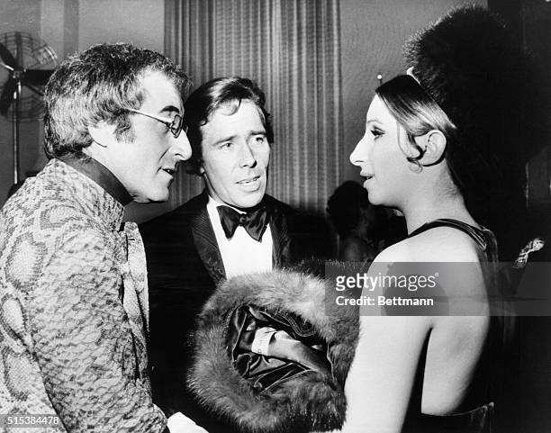 Barbra Streisand chatting with comedian Peter Sellers and Lord Snowdon at the Champagne Super party at Claridges on January 15th followed by the...