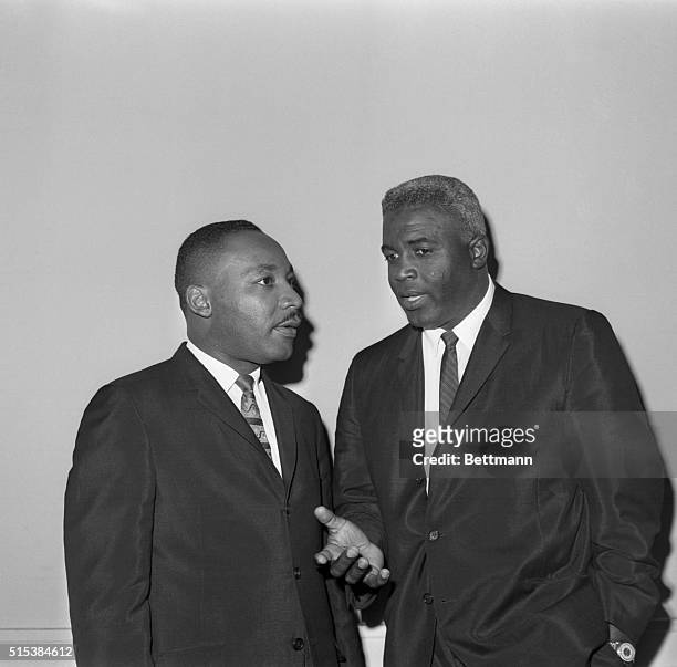 The Rev. Dr. Martin Luther King Jr. And baseball Hall-of-Famer Jackie Robinson chat together before a press conference in New York, September 19th....