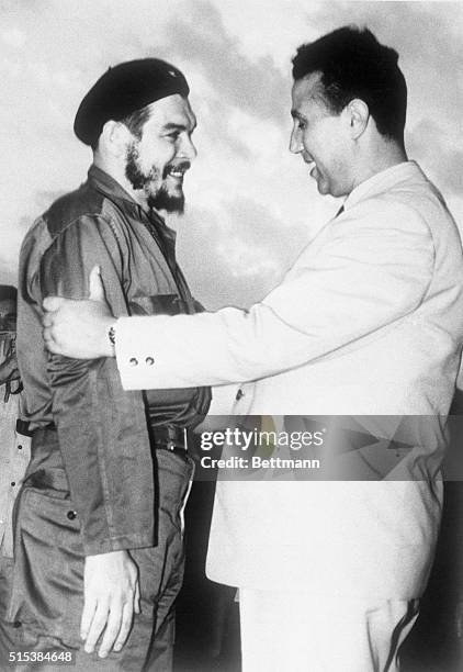 Cuba's Ernesto "Che" Guevera gets hearty greeting from Algerian Premier Ahmed Ben Bella as he arrives here July 4th. Major Guevera heads Cuban...