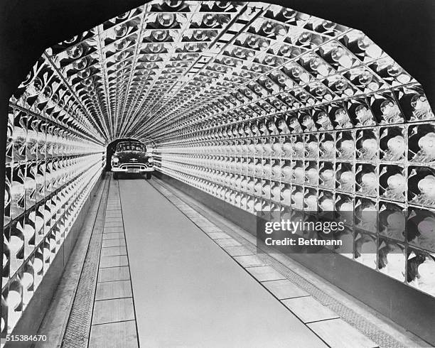 Oldsmobile enters a tunnel of infra-red lamps in the new final assembly plant at Lansing. The tunnel is one of four specially built oven s used for...