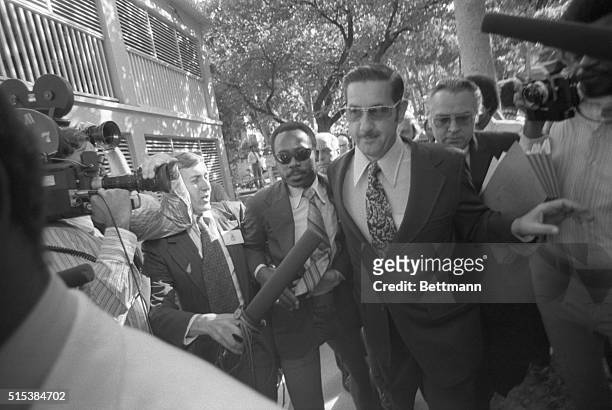 Financier Robert L. Vesco pushes his way through a crowd of newsmen and photographers as he enters court to face extradition charges. Vesco is under...