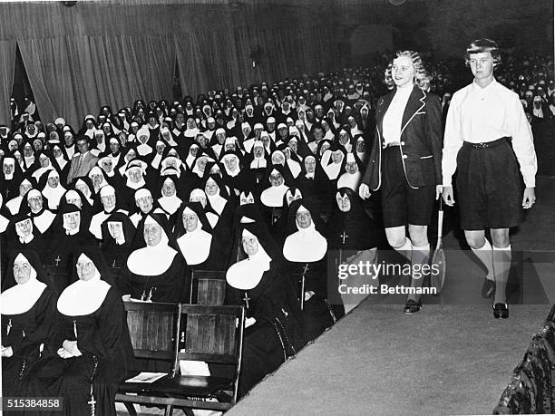 Nuns attending a teachers' organization meeting watch approvingly as Kathleen Vanderslice and Maureen Hurley model Burmuda shorts and accesories...