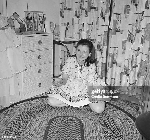 Play's the thing for Patty Duke, young star of The Miracle Worker. She enjoys a session with her jacks during rehearsal break at the Playhouse...