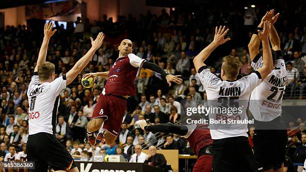 Players of Germany challenge Marko Bagaric of Qatar during a international friendly handball match between Germany and Qatar at Max-Schmeling-Halle...