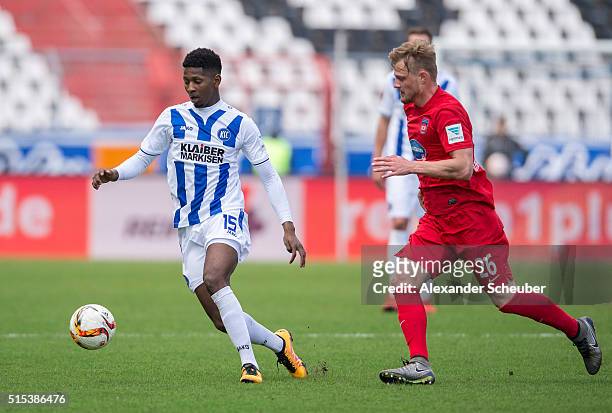 Boubacar Barry of Karlsruher SC challenges Marcel Titsch-Rivero of 1. FC Heidenheim during the second bundesliga match between Karlsruher SC and 1....