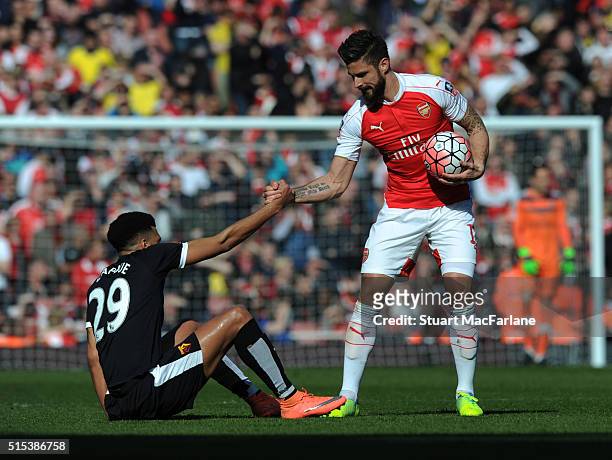 Olivier Giroud of Arsenal with Watford's Etienne Capoue during the Emirates FA Cup Sixth Round match between Arsenal and Watford at Emirates Stadium...