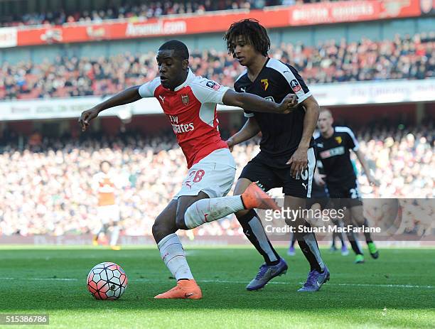 Joel Campbell of Arsenal holds off Nathan Ake of Watford during the Emirates FA Cup Sixth Round match between Arsenal and Watford at Emirates Stadium...