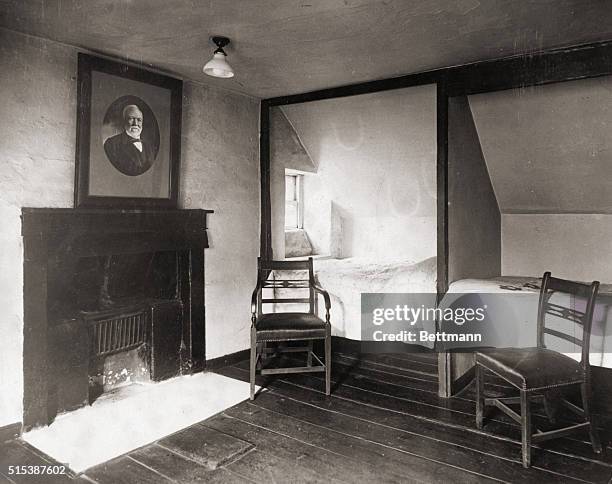 Interior of cottage where Andrew Carnegie was born, . Portrait of Carnegie hangs over the fireplace.