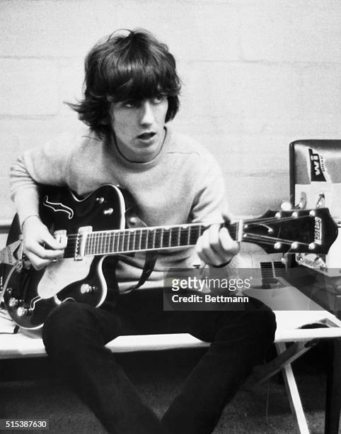 Guitarist George Harrison of The Beatles rehearsing, circa 1967.