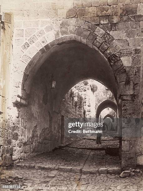 Jerusalem- Alley leading to the Palace of Herod. Undated photograph by Bonfils. Phhotograph shows figures of boy and in the distance a man standing...