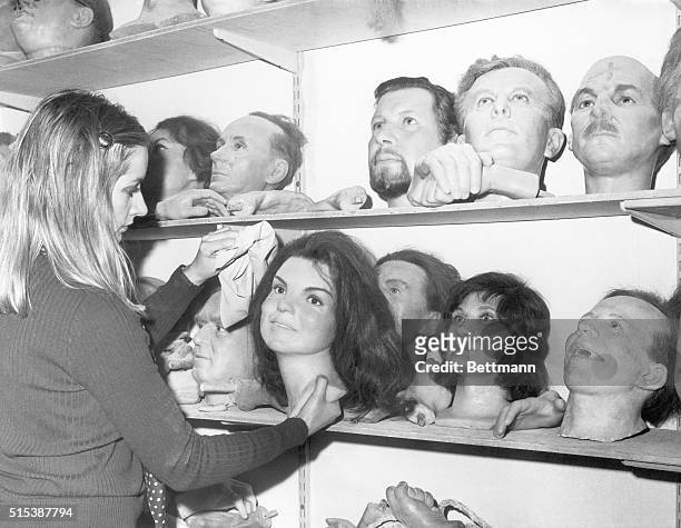Head" of Mrs. Jacqueline Kennedy Onassis is dusted in a storeroom that is a kind of "death row" at Madame Tussaud's Waxworks in London. "Heads" of...