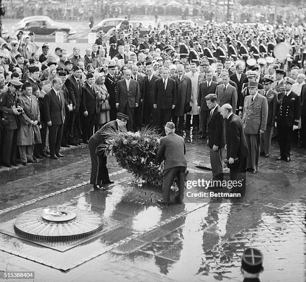 President Kennedy and French President De Gaulle observe American Legionnaires lay a wreath on the Tomb of the Unknown Soldier.