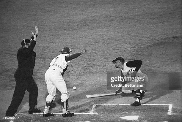Pirate's Roberto Clemente slumps to the ground in back of the plate in pain after he was hit by a ball pitched by Dodgers' Don Drysdale, in the...