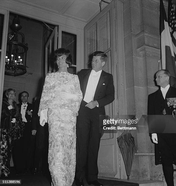 President John F.Kennedy and his wife, Jacqueline, leave the French Foreign Ministry here, May 31st, in evening clothes, for a reception at Elysee...