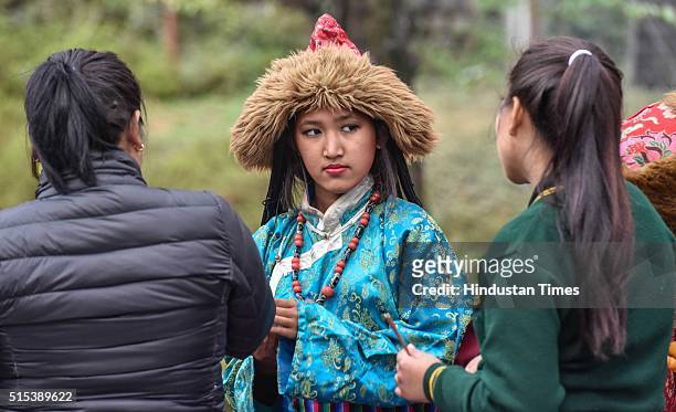 Tibetan exile girls dressed up in traditional dress reach before the arrival of Tibetan spiritual leader Dalai Lama at Dharamsala, as he arrived from...