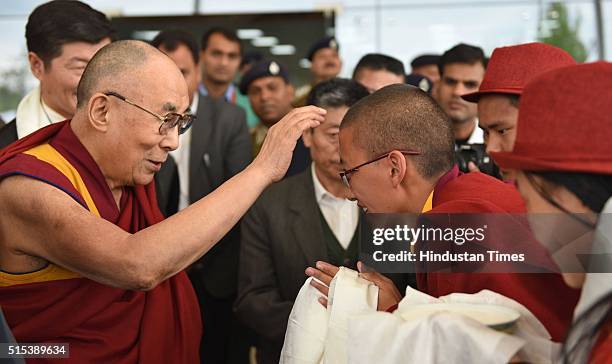 Tibetan spiritual leader Dalai Lama giving away blessings to Tibetan Buddhist Nuns at Kangra Airport, Gaggal, as he arrived from Minnesota, USA after...